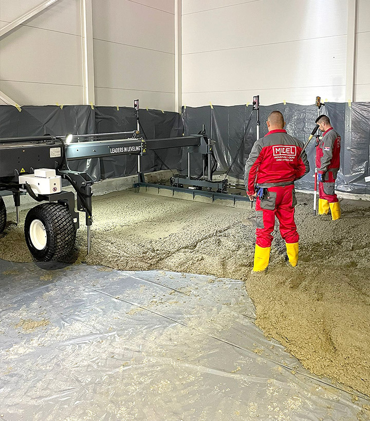 laser screed leveling and vibrating concrete slab