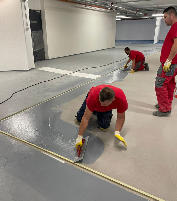 Midel workers make the epoxy floor in the field